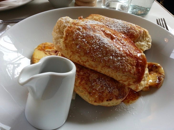 Pancakes on a white dish with jug