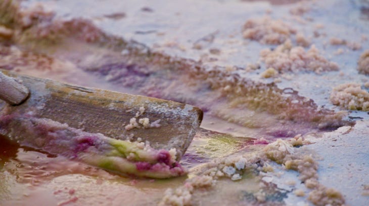 A close-up of salt being scraped from a salt flat