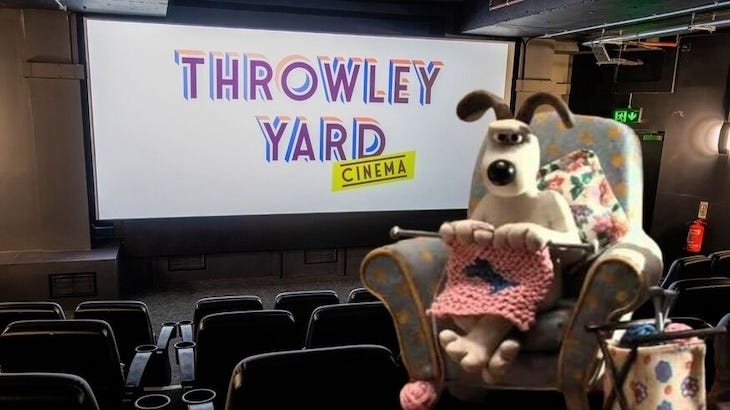 Grommit knitting in front of a cinema screen