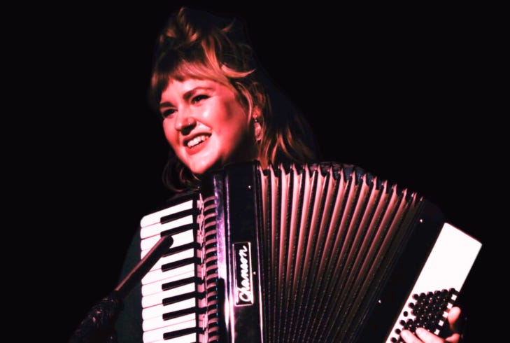 A woman playing an accordian