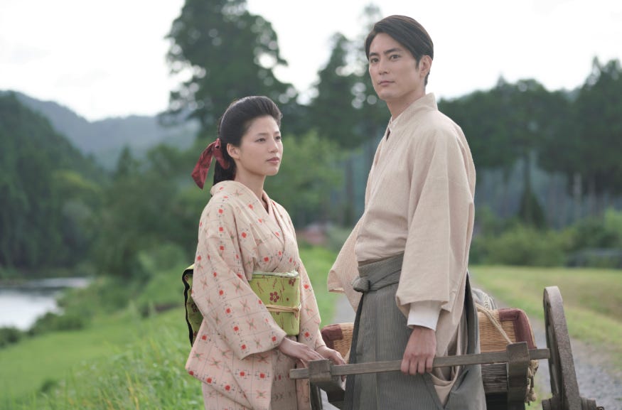 A photograph of a man and woman standing together in a field