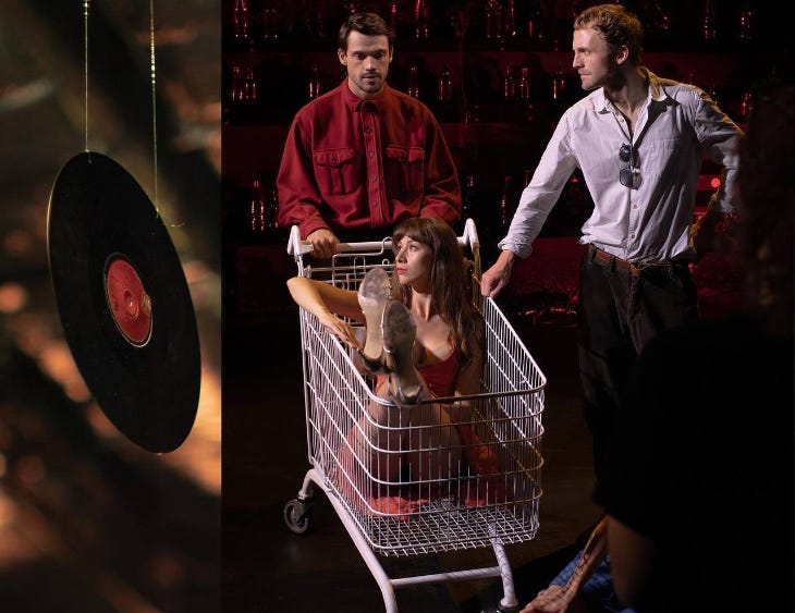 A woman sitting in a shopping trolley with two men standing next to it