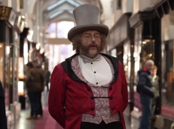 A whistling man in Burlington Arcade dressed in a ringmaster's outfit like a champ