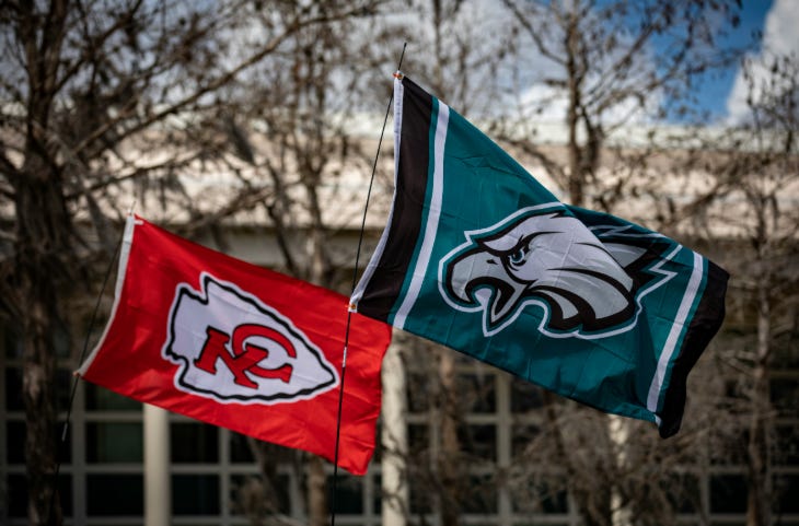 The Kansas City Chiefs flag (upside down) and Philadelphia Eagles flag flying next to each other