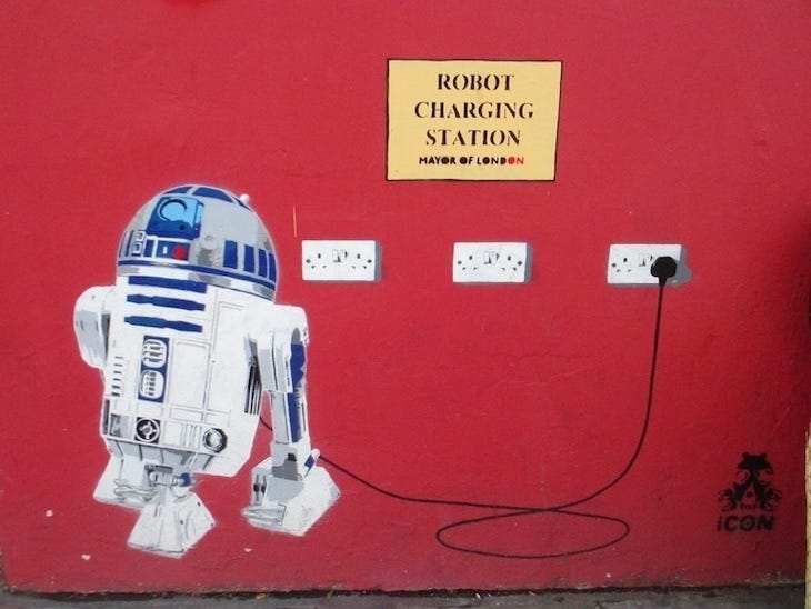 a street art R2D2 being charged