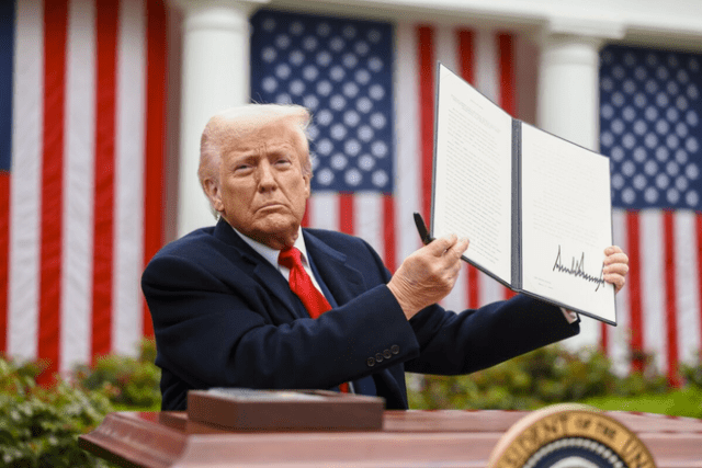 President Donald Trump holds a signed executive order on tariffs, in the Rose Garden at the White House in Washington, D.C., April 2, 2025.