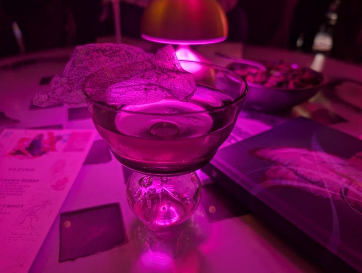 A cocktail bathed in pink light