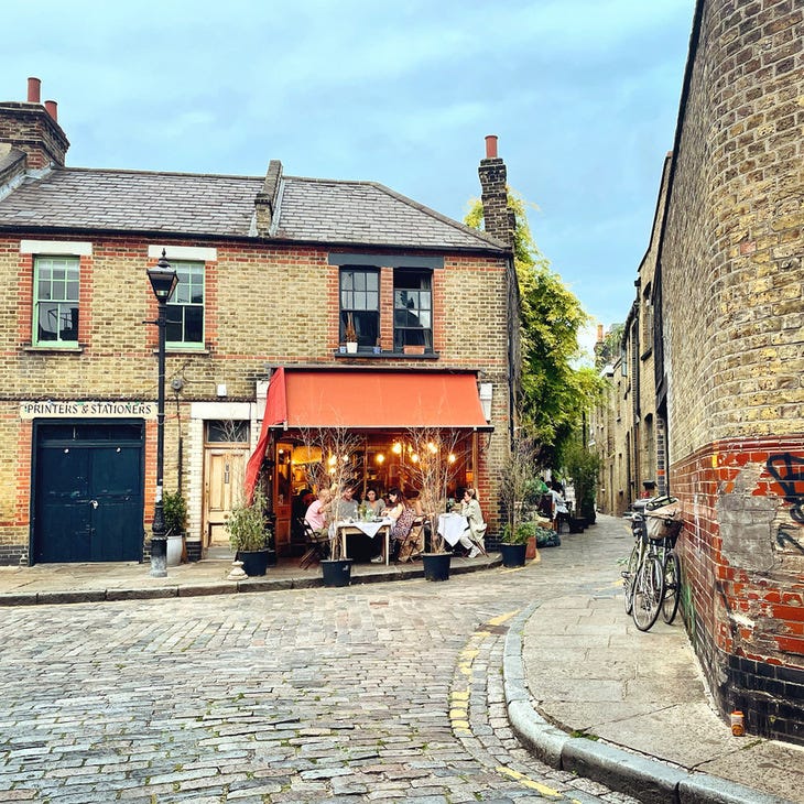 A beautiful looking restaurant in a brick building on a cobbled street