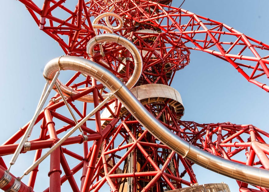 A silver slide on the outside of the red twisty Arcelor Mittal Orbit structure