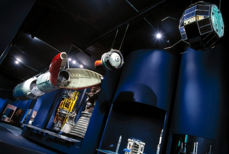 Part of a rocket hanging from the ceiling in a museum gallery
