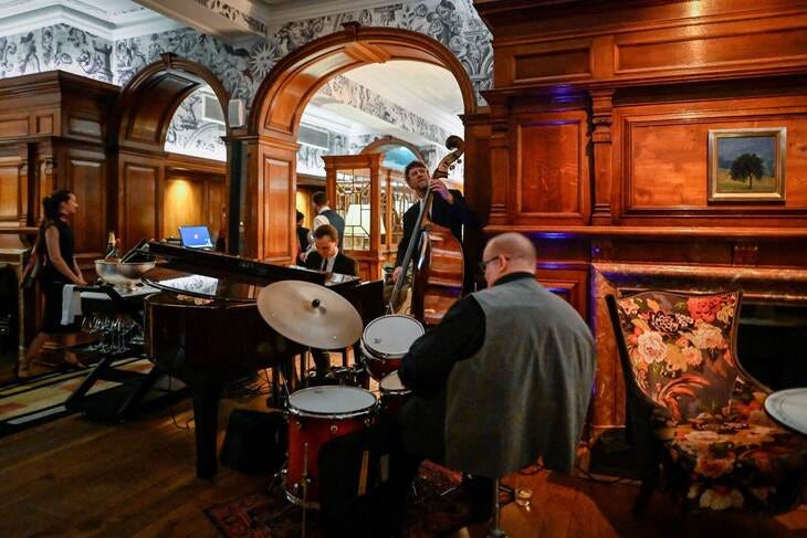 A jazz outfit playing in a wood panelled room