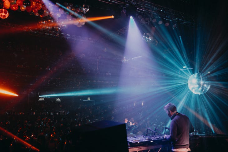 A disco with bright lights and dj