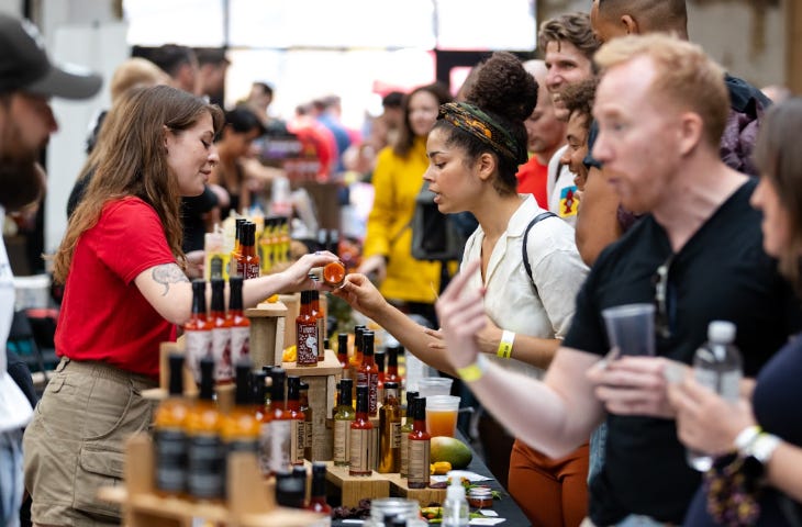 People looking at sauces on a stall at the Hot Sauce Festival