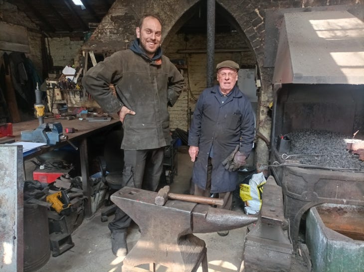 Two blacksmiths in the forge
