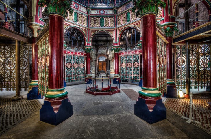 The interior of Crossness Pumping Station, an ornate building decorated in green, red and gold