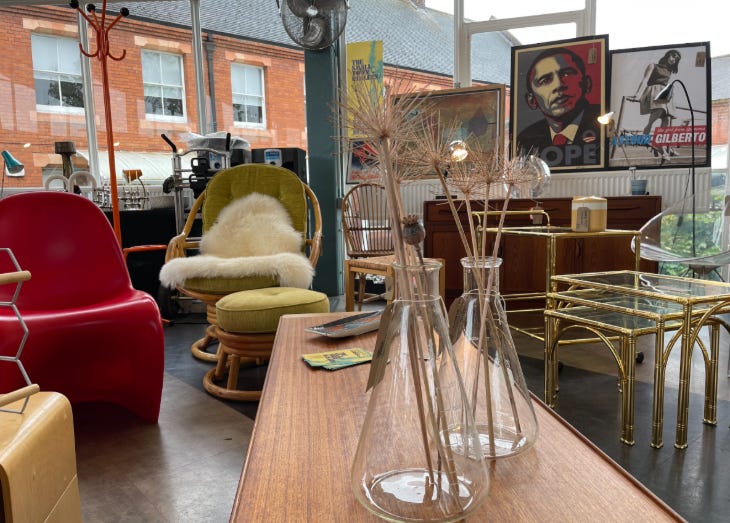 Furniture, vases and posters on display at a vintage fair