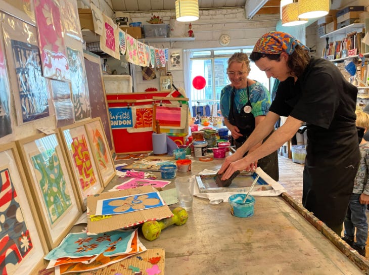 Two people taking part in screen printing