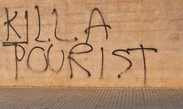 A graffiti reading 'Kill a tourist' A graffiti reading 'Kill a tourist'