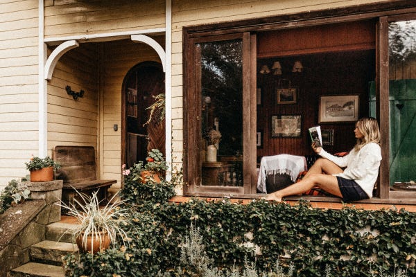 Woman reading on a windowsill. Image courtesy of Jonathan Borba.