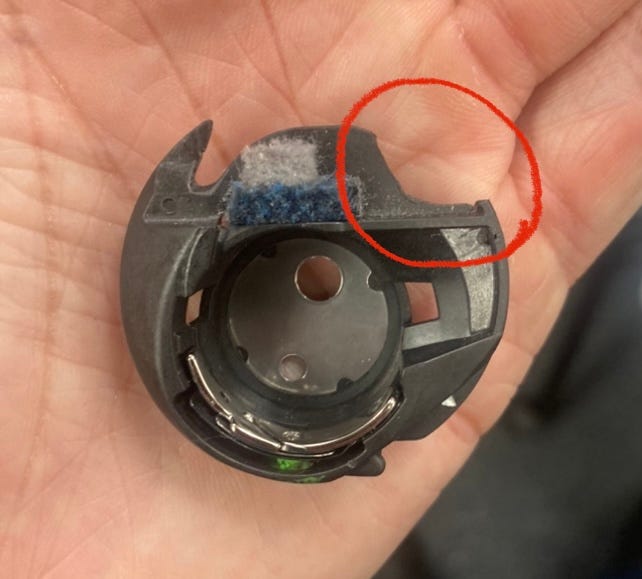 Bobbin case with a chunk missing from needle strikes
