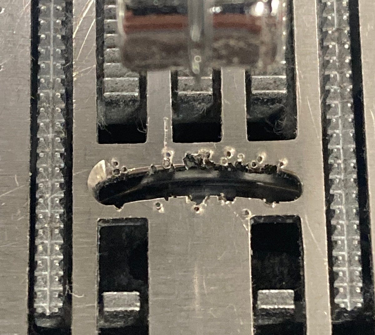 Sewing machine needle plate damaged by repeated needle strikes
