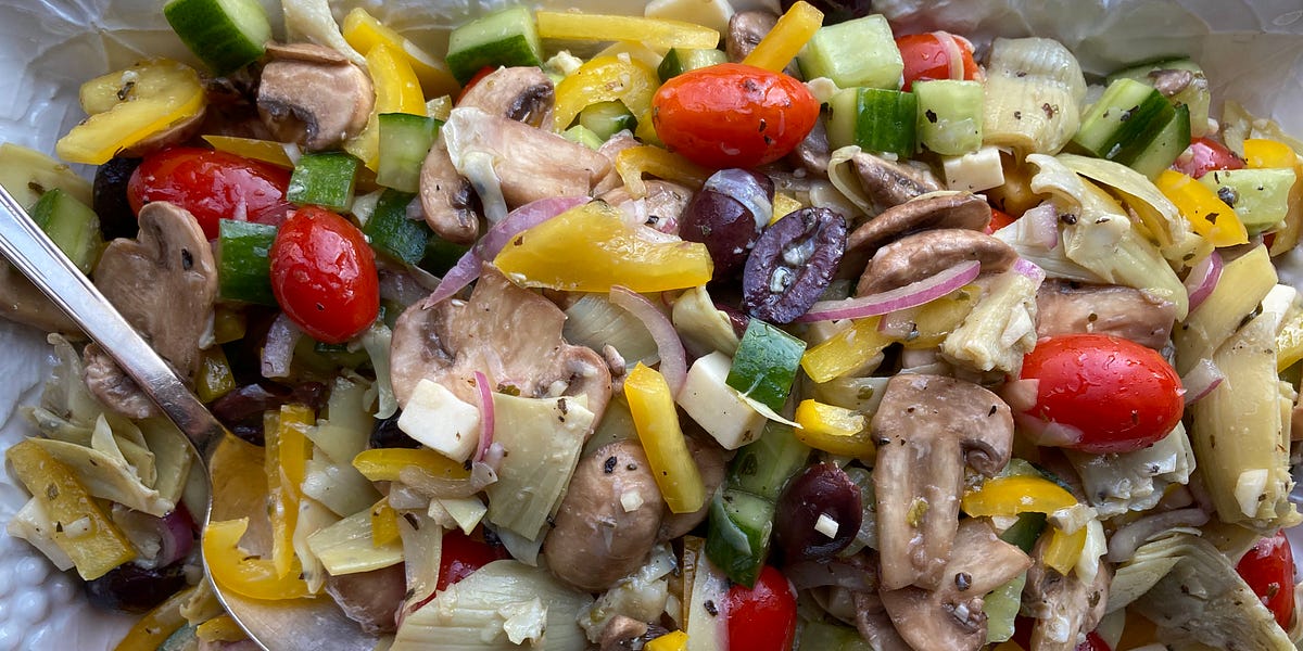 Chopped antipasto salad with mushrooms, pepper, cherry tomatoes, artichoke hearts and red onion.