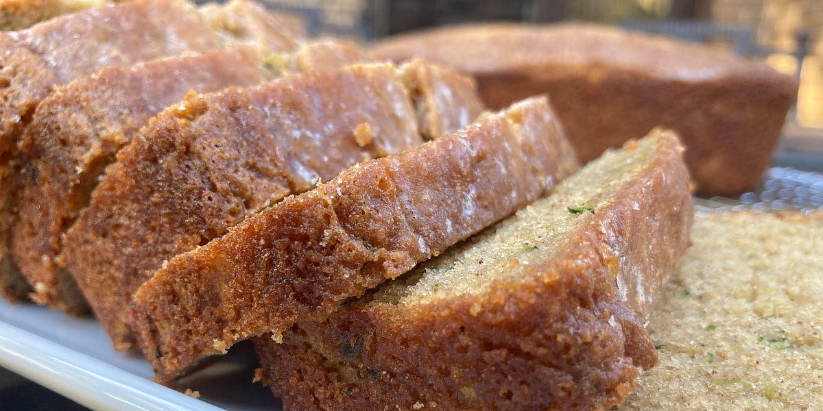 Slices of zucchini bread on a white serving tray.