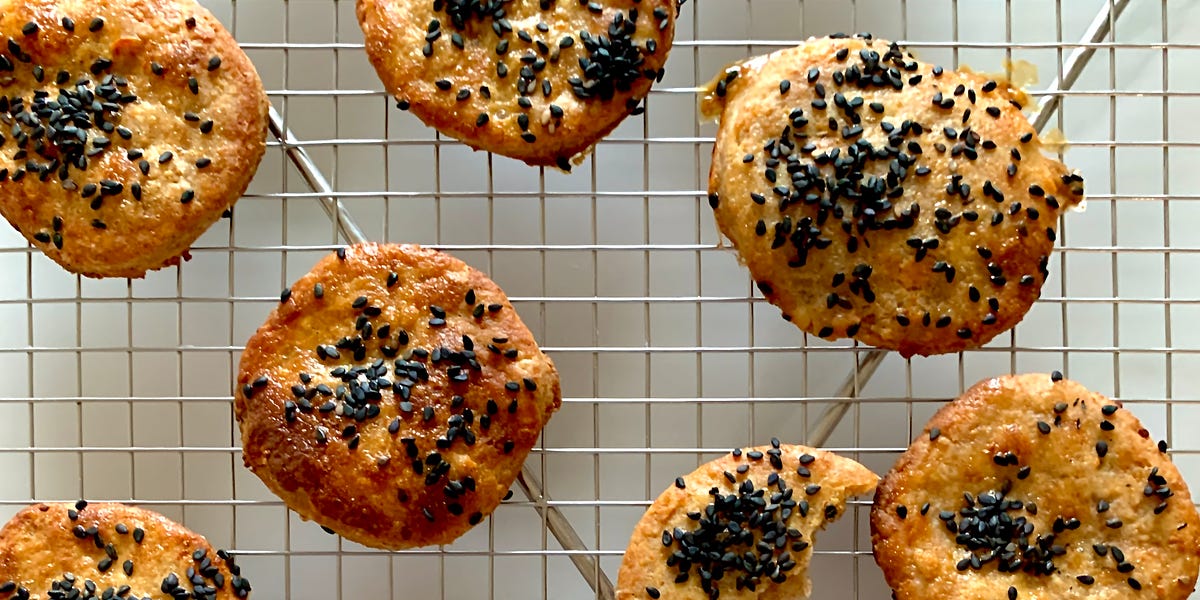 Crispy cookies on a rack, covered with black sesame seeds