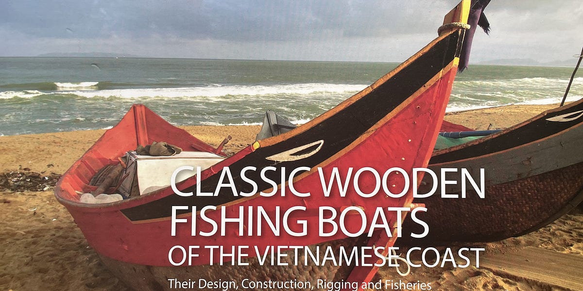 Traditional Vietnamese fishing boat and hand made raft at anchor