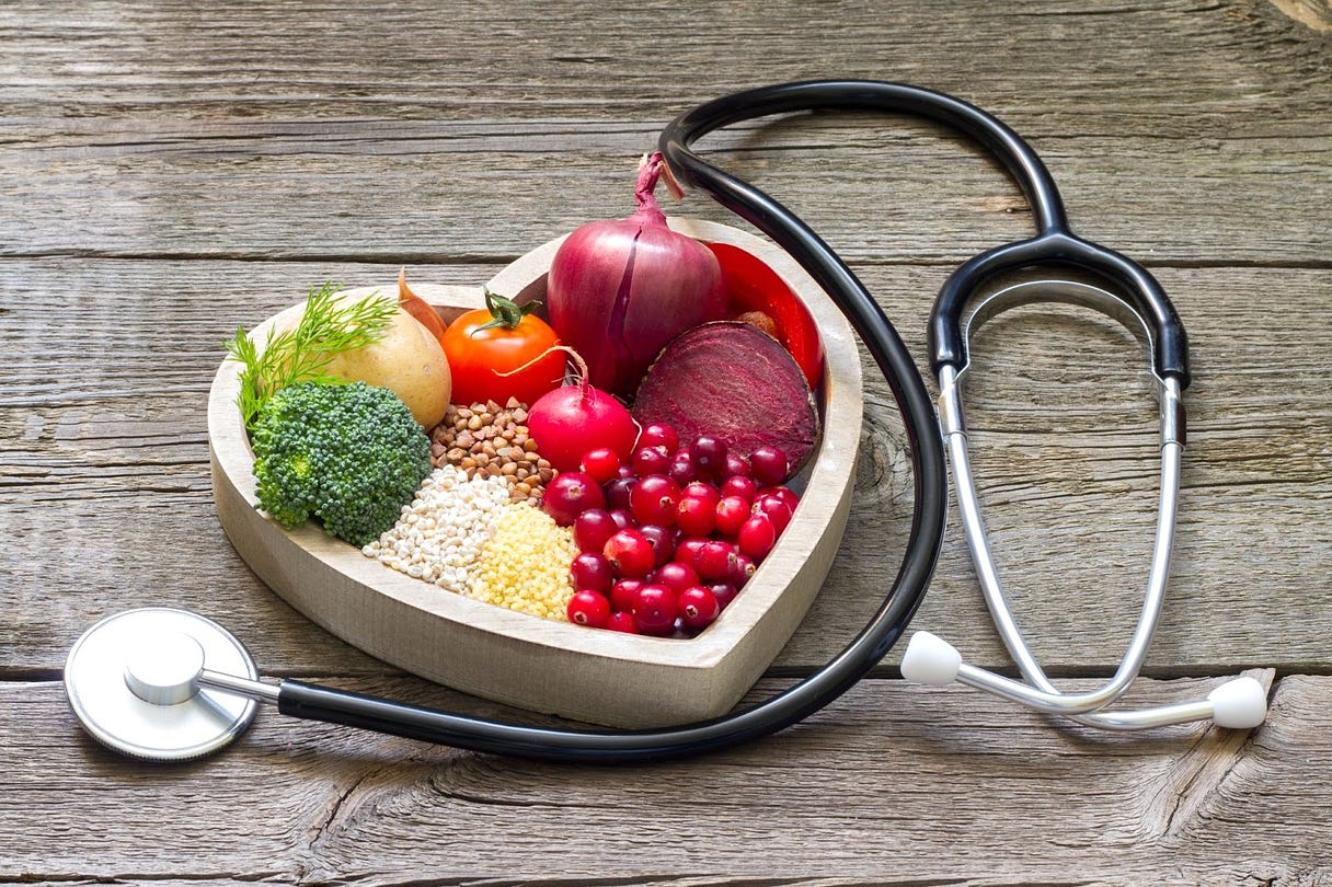 A heart shaped bowl with vegetables and a stethoscope

Description automatically generated