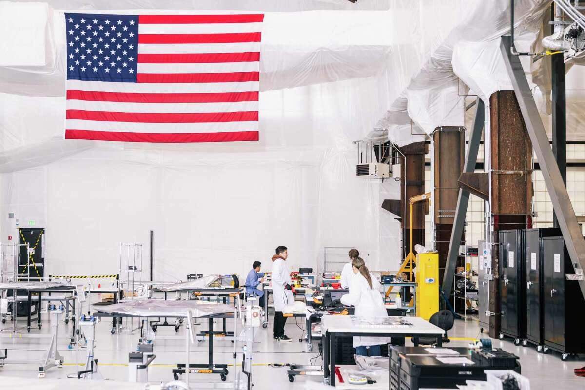 Technicians work in a climate-controlled facility at Astranis in San Francisco, which is building satellites that it plans to send to orbit more than 22,000 miles above the Earth’s surface.