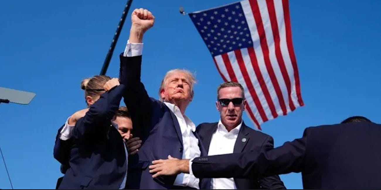 Here is the Second Assistant Director...errr, SECRET SERVICE... ushering Photographers to the Front of the Stage immediately before the Trump shooting action scene