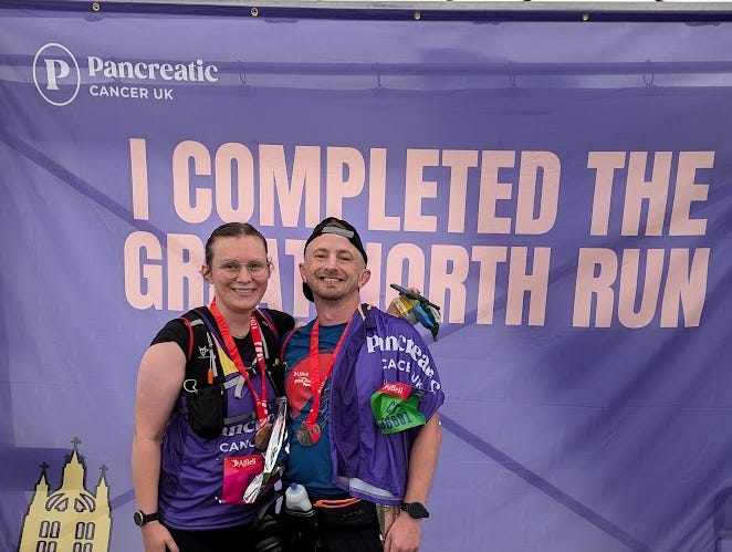 Craig and Ellen posing at the finish with their medals