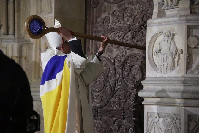 Archbishop of Paris, Laurent Ulrich, knocks on the door of Notre-Dame Cathedral during a ceremony to mark the re-opening of the landmark Cathedral, in central Paris, on Dec. 7, 2024.