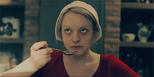 Elisabeth Moss eating with a spoon in 'The Handmaid's Tale.' Elisabeth Moss eating with a spoon in 'The Handmaid's Tale.'