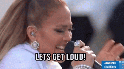 gifje van Jennifer Lopez die Lets get Loud zingt. Je ziet ook de Amerikaanse vlag en de tekst lets get loud
