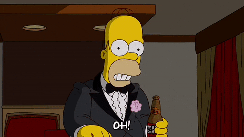 Homer Simpson in a tuxedo drinking beer sadly.