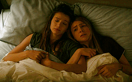 Blair and Sterling hugging each other in bed
