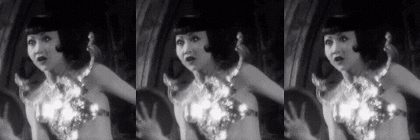 GIF of Anna May Wong throwing a pie (times 3) from the film Elstree Calling (1930)