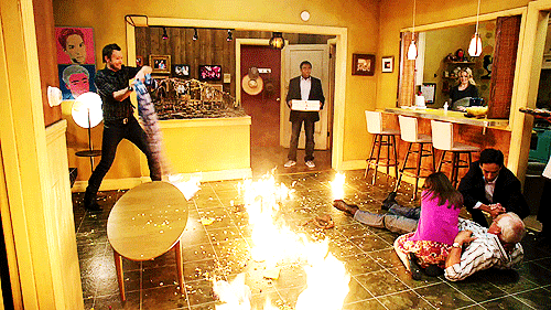 The wide shot of the Community scene where Donald Glover returns to the apartment and finds chaos. Fire, blood, mayhem. Jeff is swinging a burning shirt, the floor is aflame. Chevy is bleeding out and Annie tries to stem the flow. Abed is out of frame, but relatively calm. 