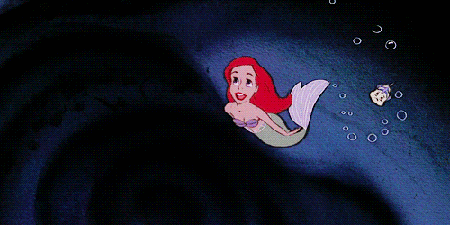 Ariel the Little Mermaid does a backflip as she swims upward towards the light in her cavern of treasures, followed closely by Flounder, singing Part of Your World