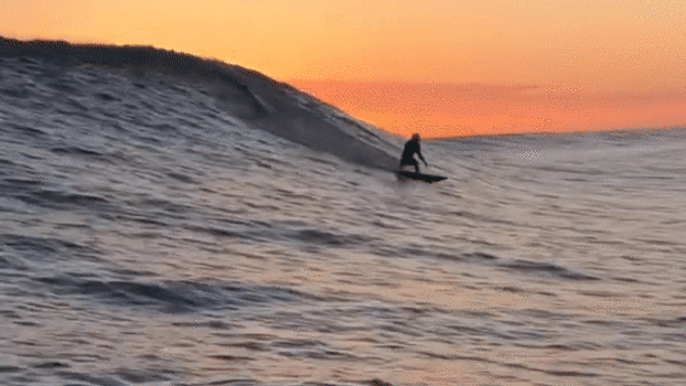 Australian Surfer Rides Barrel Wave as Sun Sets