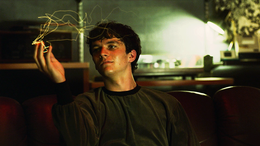 Jake Gyllenhaal marvels at light streaming from his fingertips in the movie Donnie Darko