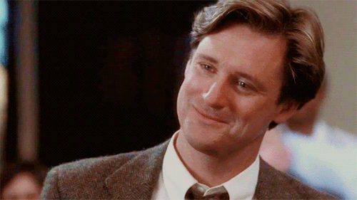 Bill Pullman in While You Were Sleeping smiling and looking down