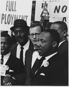 Martin Luther King, Jr., speaking surrounded by other men.