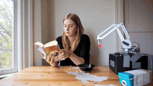 Simone Giertz eating cereal with bad robot