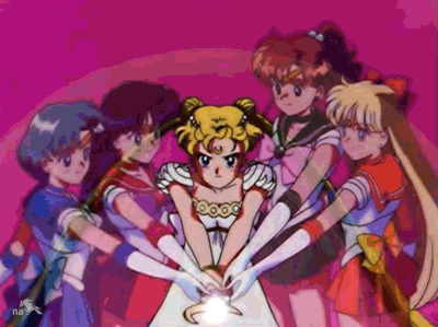 Sailor Moon, now as Neo Queen Serenity, aims her wand towards the camera and fires a beam of white light. On her left, the ghosts of Sailor Jupiter and Venus puts their hands on the wand to provide energy and support. On her right, the ghosts of Sailor Mercury and Mars do the same. Arcs of light radiate out as ripples from the center against a pink background behind all the characters.