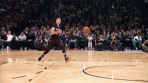 Gif of man alley-ooping and dunking a basketball. Gif of man alley-ooping and dunking a basketball.
