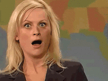 A gif of Amy Poehler on SNL's Weekend Update, giving a fake shocked face to the camera.