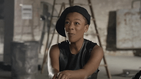 Samira Wiley in a black beret extending her arms. Samira Wiley in a black beret extending her arms.